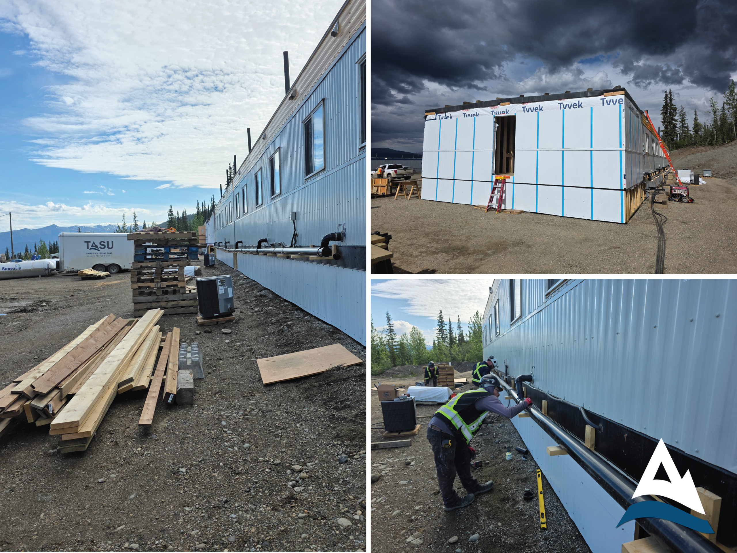 Tasu crew installing a modular dormitory at the Hecla Keno Hill mine site in the Yukon, showing exterior skirting, a Tyvek-wrapped boot room addition, and utility tie-in work